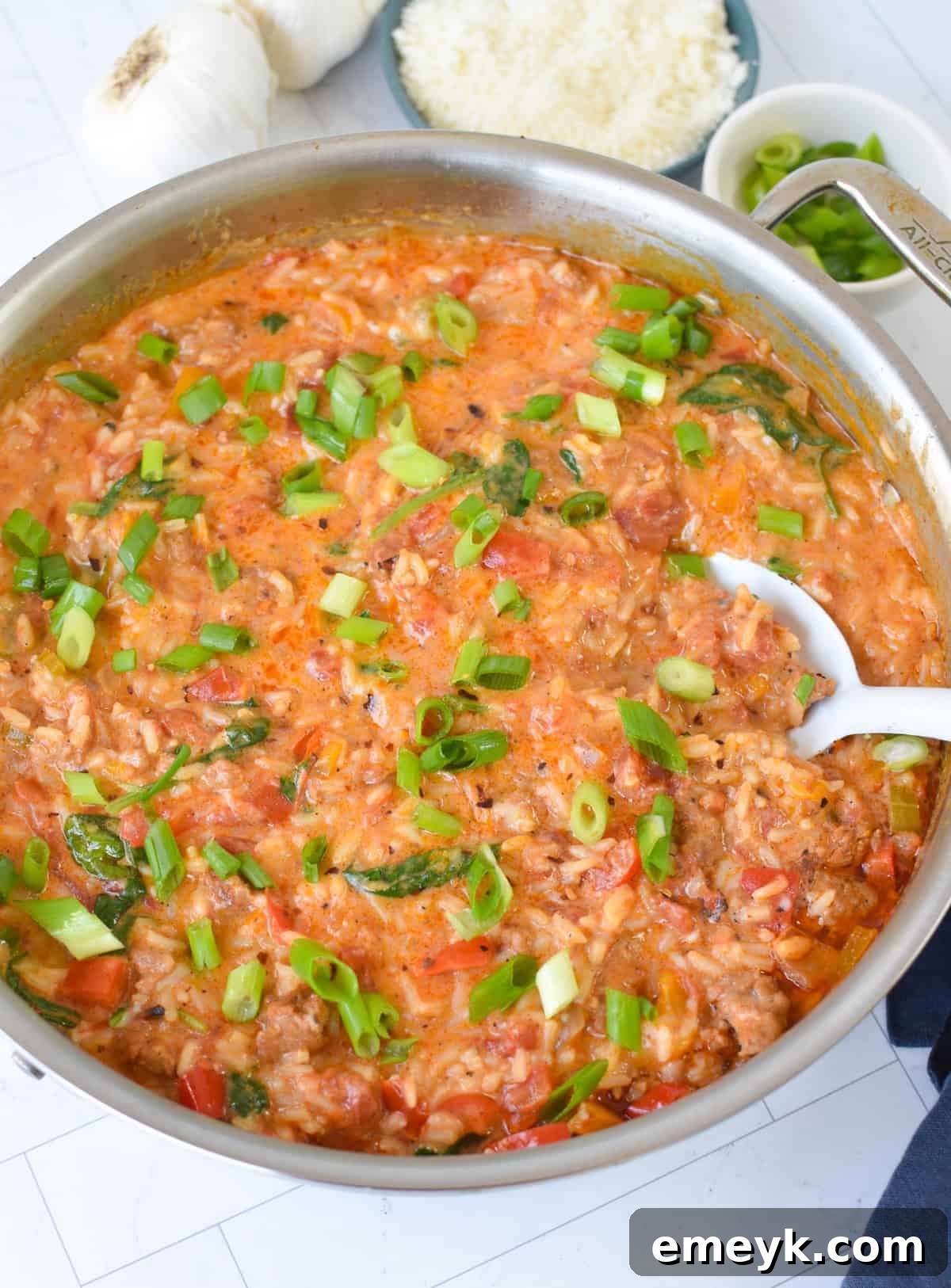 Creamy Cajun Sausage Rice Skillet garnished with fresh green onions