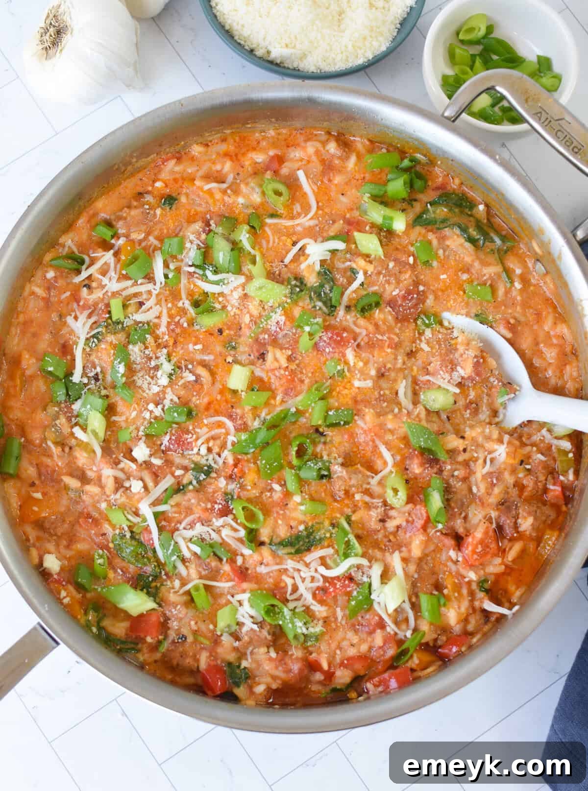 Heavy cream added to the Creamy Cajun Sausage Rice Skillet in the pan