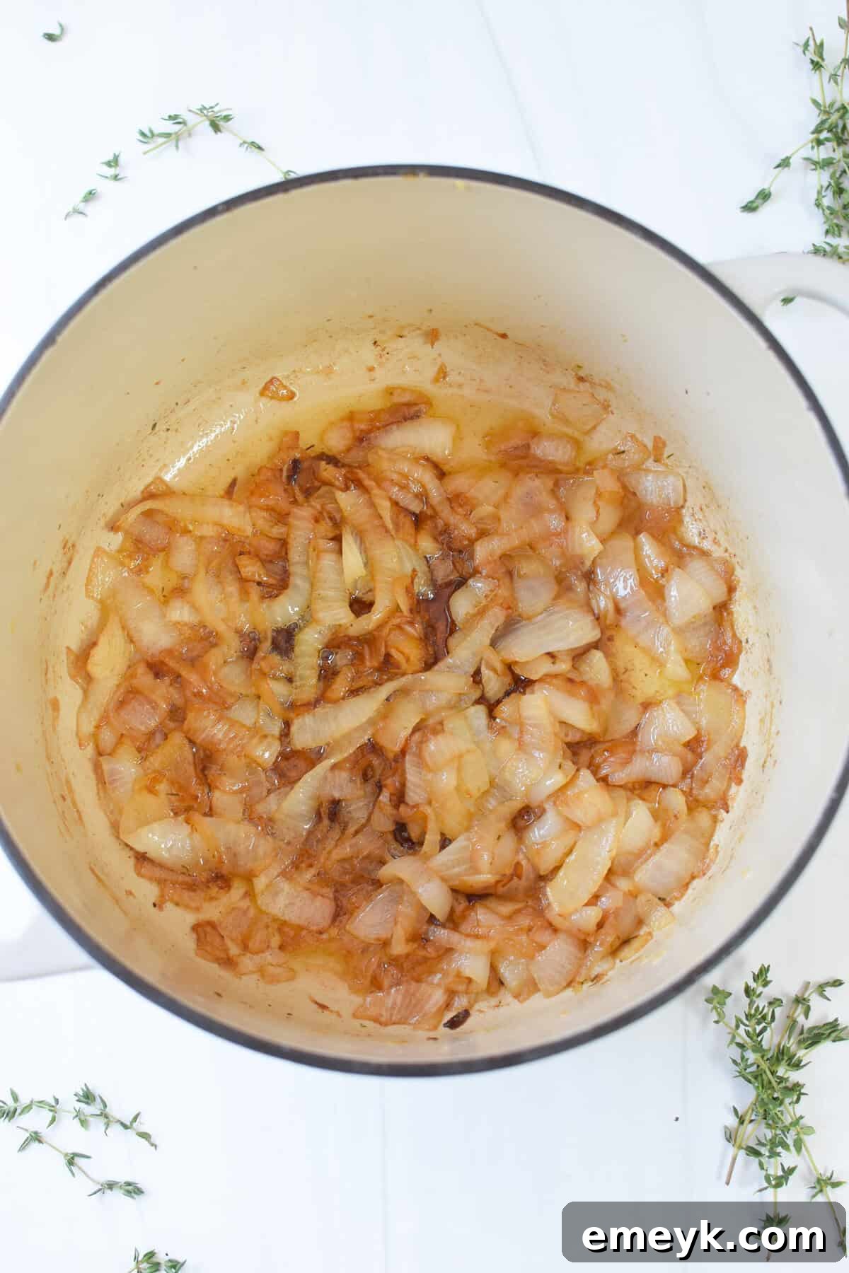 French Onion Smothered Pork Chops 6 Thinly sliced yellow onions slowly caramelizing in melted butter within a Dutch oven