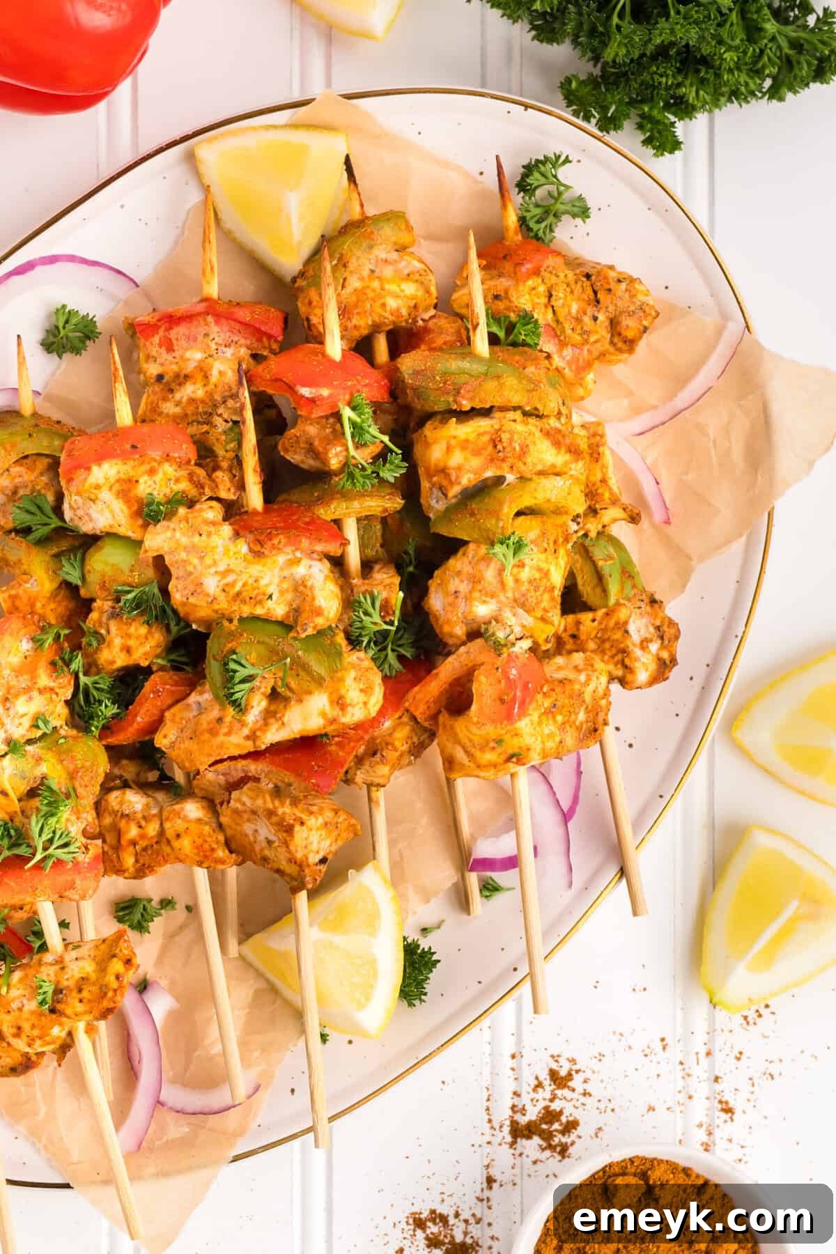 Tender Chicken Tikka Kebabs artfully arranged on a plate, ready to be served.
