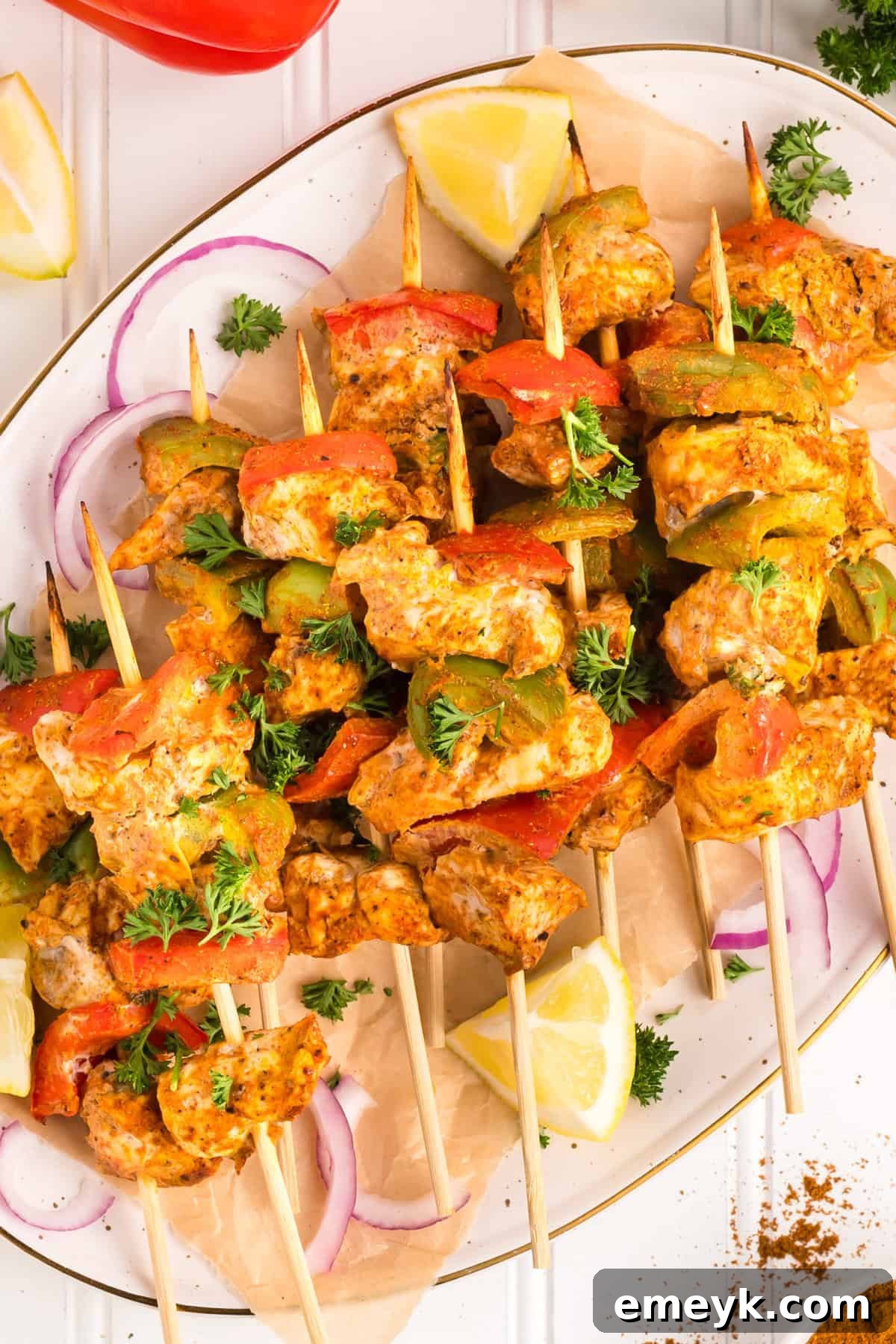 Multiple Chicken Tikka Kebabs presented on a large serving plate, ready to be enjoyed.