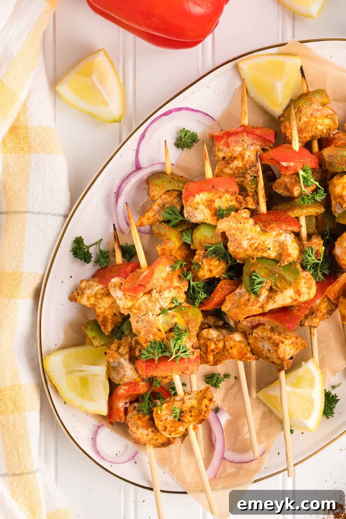 A vibrant platter of freshly cooked Chicken Tikka Kebabs, showcasing their rich color and inviting texture.
