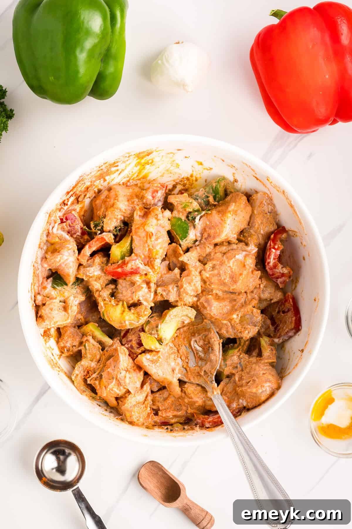 Marinated chicken mixture resting in a bowl, ready for skewering and cooking.