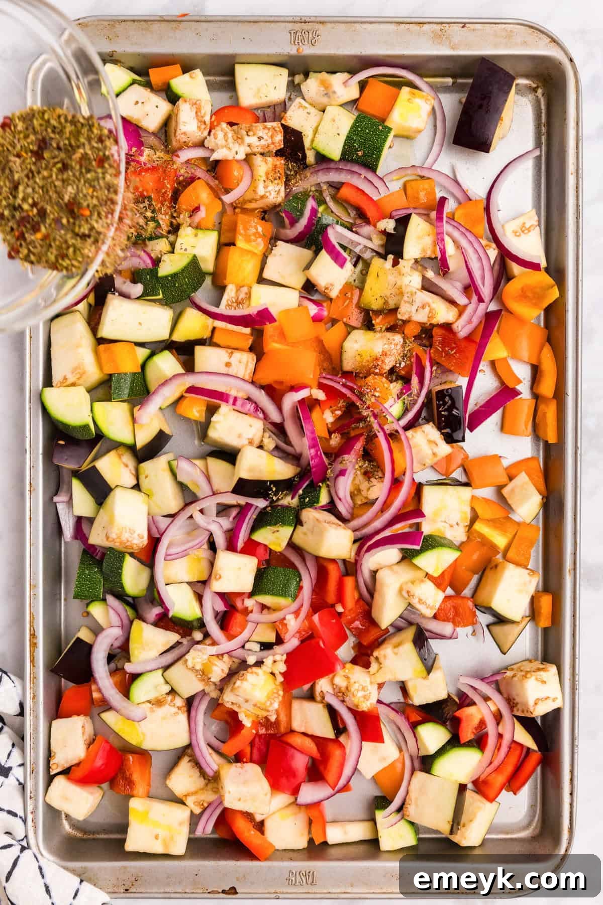 Mediterranean Harvest Roasted Pasta Bake 6 Roasted vegetables seasoned with spices on a baking sheet, showing their caramelized texture