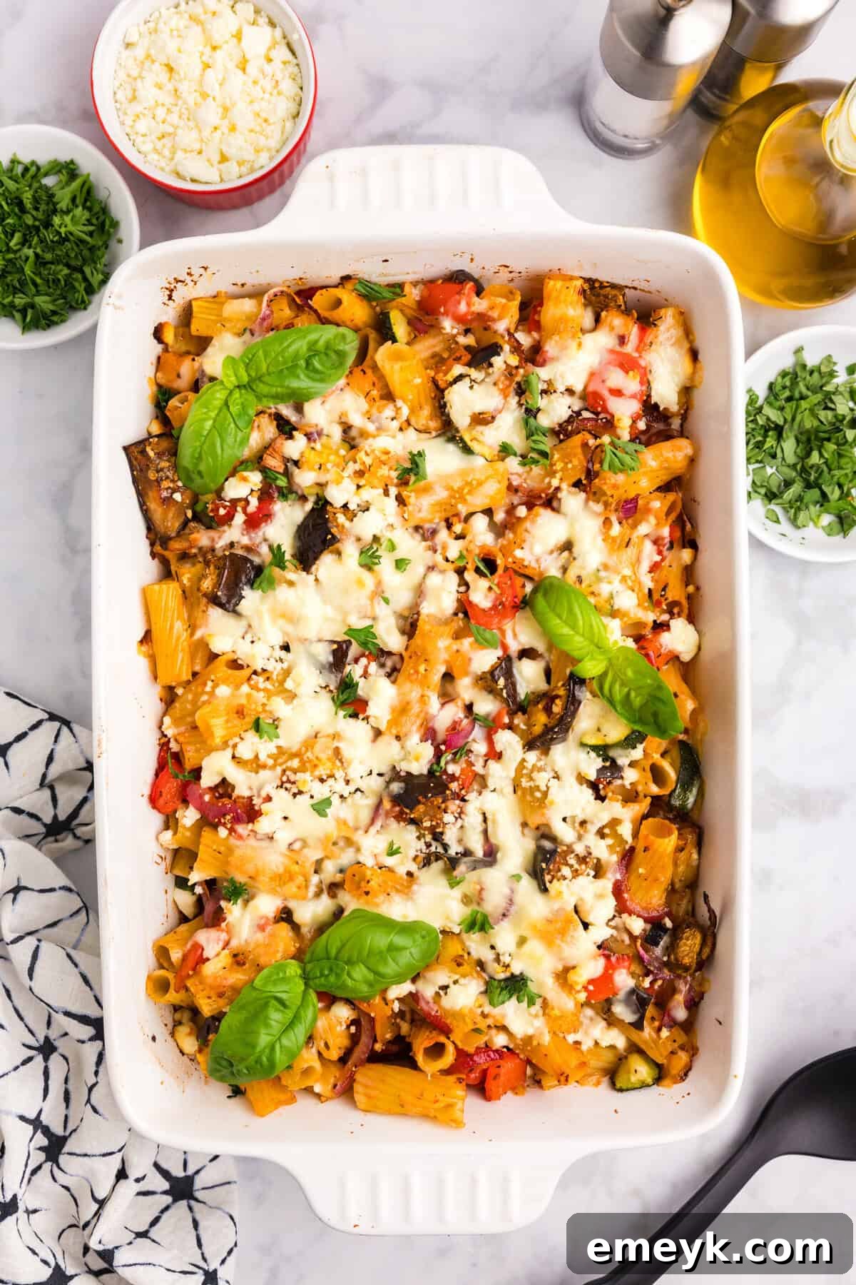 Mediterranean Harvest Roasted Pasta Bake 8 A serving of Mediterranean Roasted Vegetable Pasta Bake garnished with fresh basil, showcasing its inviting presentation