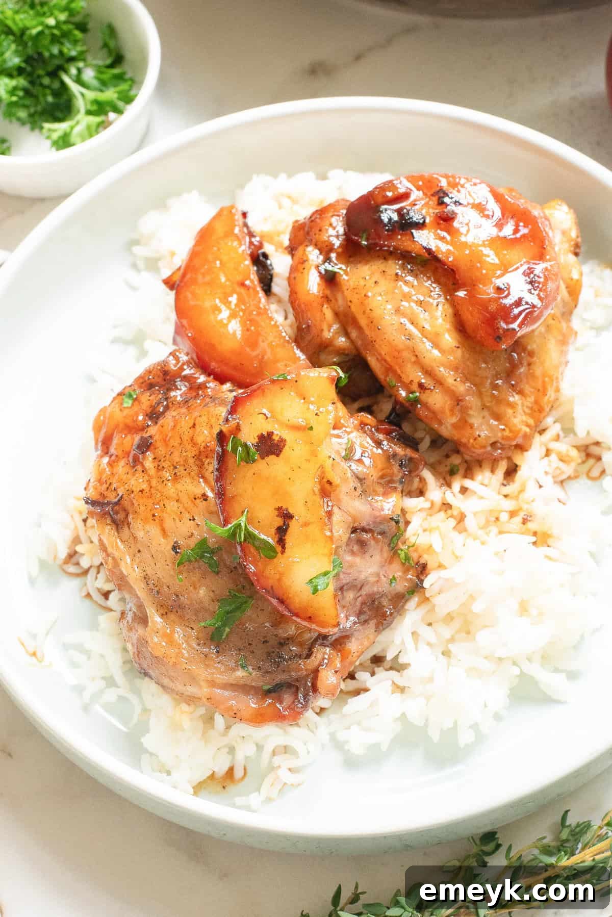 Skillet Apple Cider Chicken served over a bed of fluffy white rice, ready to eat.