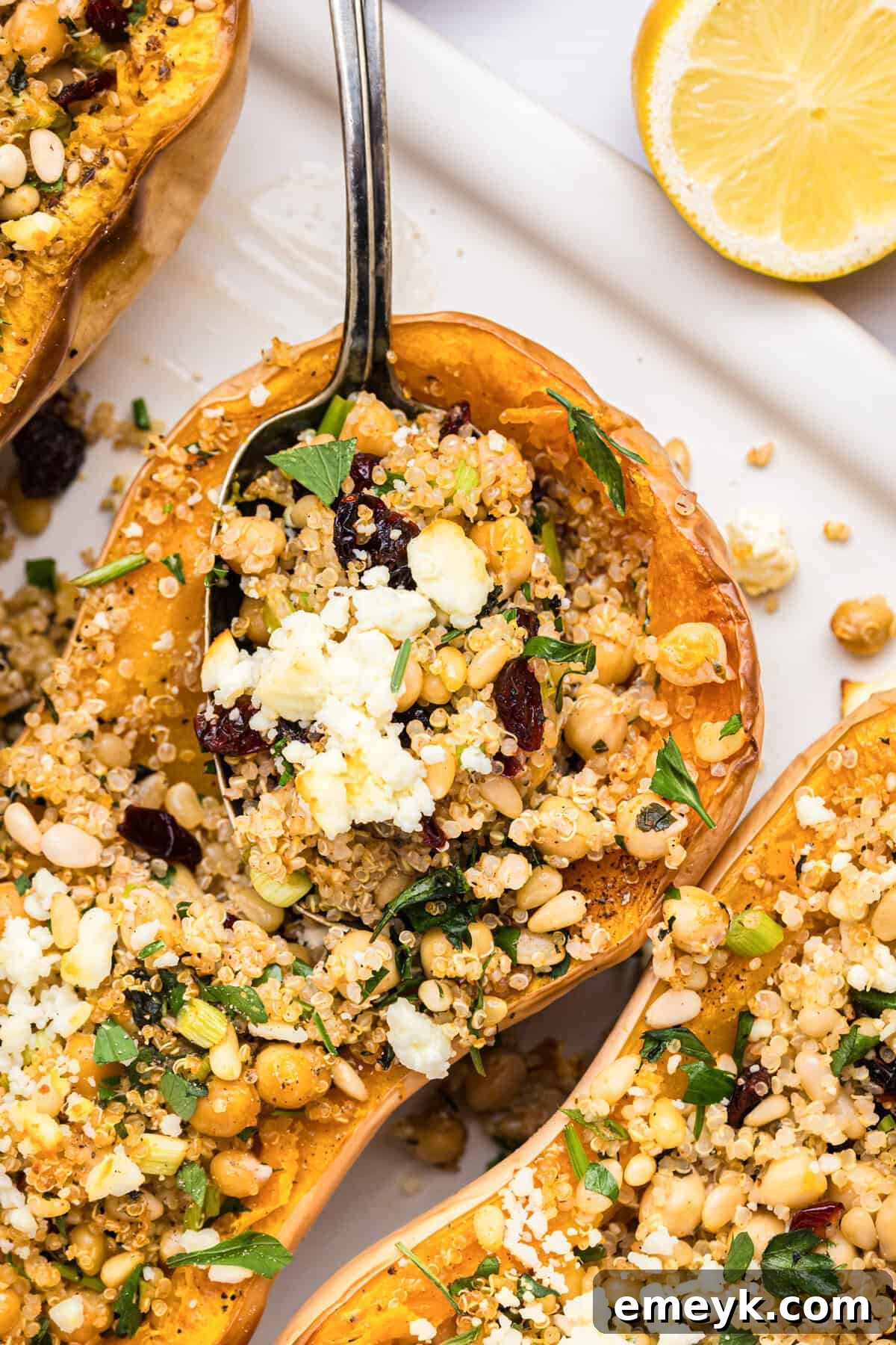 Sun-Kissed Mediterranean Stuffed Butternut 3 Mediterranean Stuffed Butternut Squash with spoon on a baking sheet