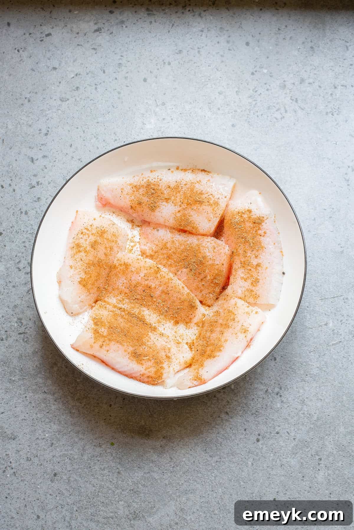 Mahi Mahi fish pieces coated in blackening spices in a bowl, ready for cooking