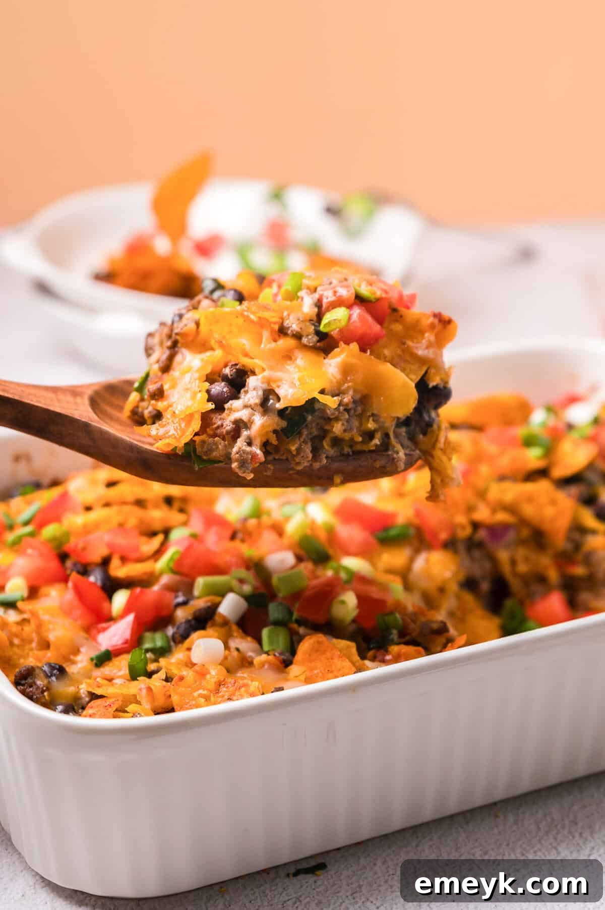 A vibrant Doritos Taco Casserole in a casserole dish, ready to be served, showing its cheesy, crunchy topping.