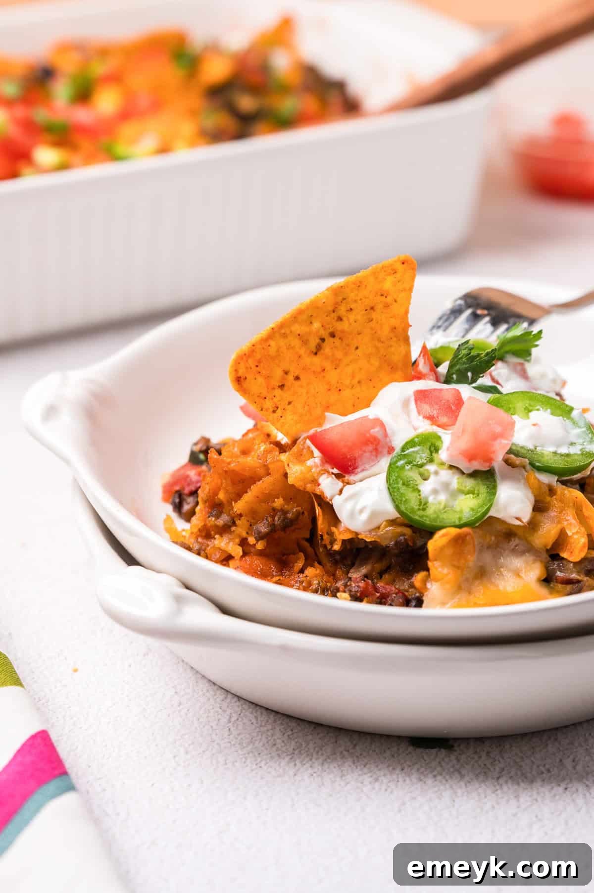 A close-up shot of Doritos Taco Casserole in a serving bowl, showcasing its rich texture and colorful ingredients.