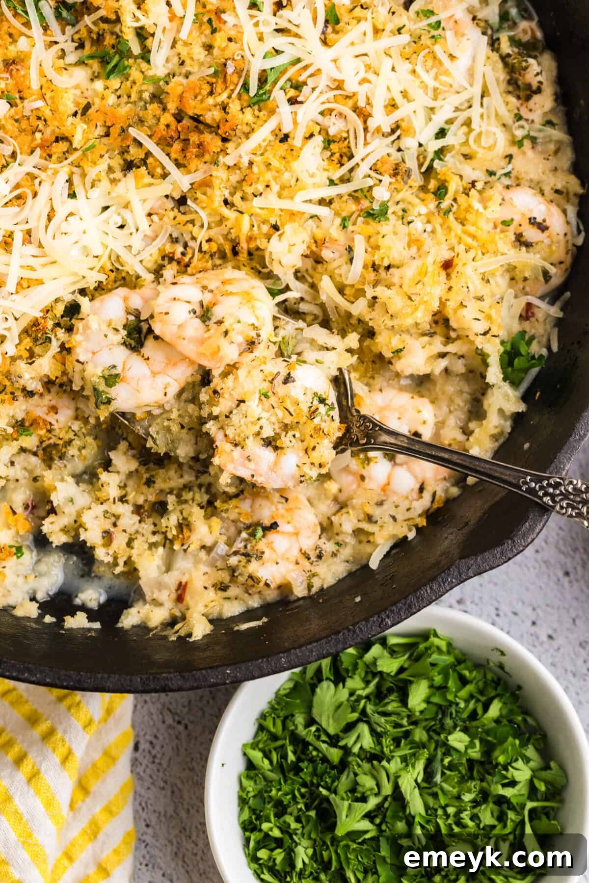 Effortless Crispy Shrimp 12 Easy Breaded Shrimp in a cast iron skillet with a spoon