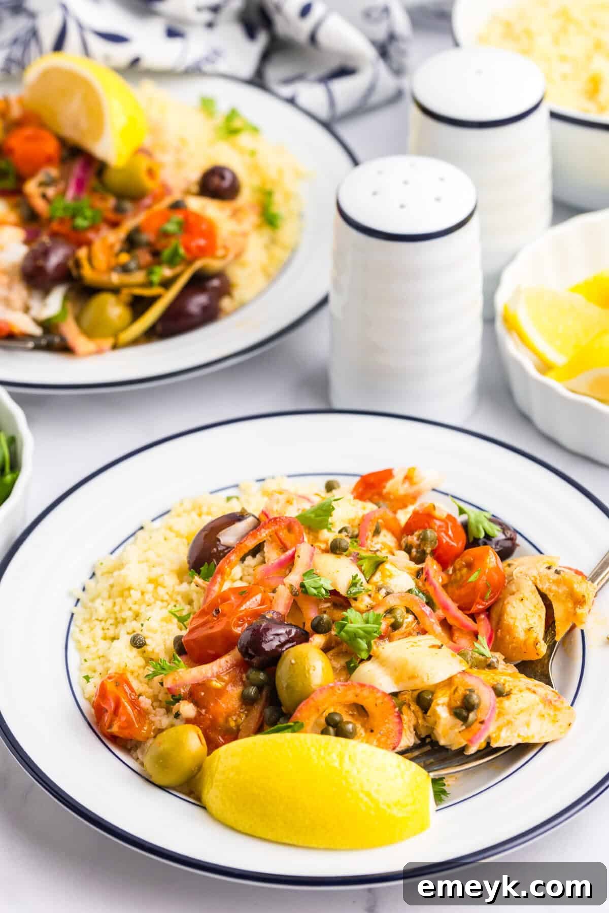 Sun-Kissed Mediterranean Fish Bake 7 Two plates of Mediterranean Baked Fish, beautifully garnished.