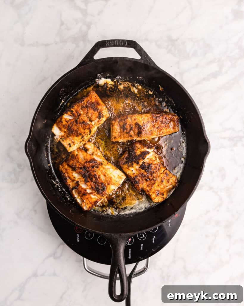 Effortless Blackened Cod 11 Easy Blackened Cod cooking in a hot cast iron skillet