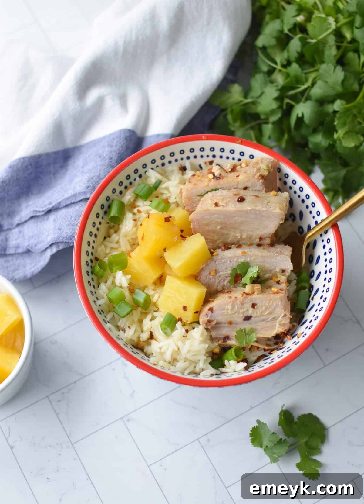 A fork holding a piece of tender Slow Cooker Pineapple Pork Loin, demonstrating its succulent texture.
