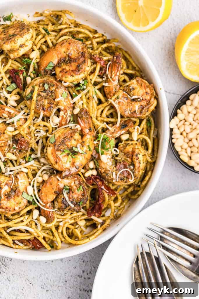Vibrant Pesto Shrimp Pasta 2 Delicious Shrimp Pesto Pasta served in a bowl, garnished with fresh basil.