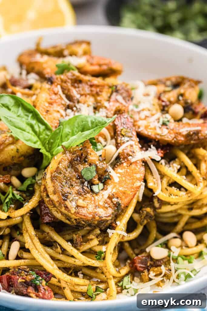 Vibrant Pesto Shrimp Pasta 10 Shrimp Pesto Pasta in a serving bowl, garnished with fresh basil leaves.