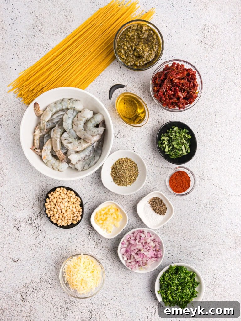 Vibrant Pesto Shrimp Pasta 5 A flat lay photograph showcasing all the fresh ingredients needed for Shrimp Pesto Pasta, including pasta, shrimp, pesto, sun-dried tomatoes, and seasonings.
