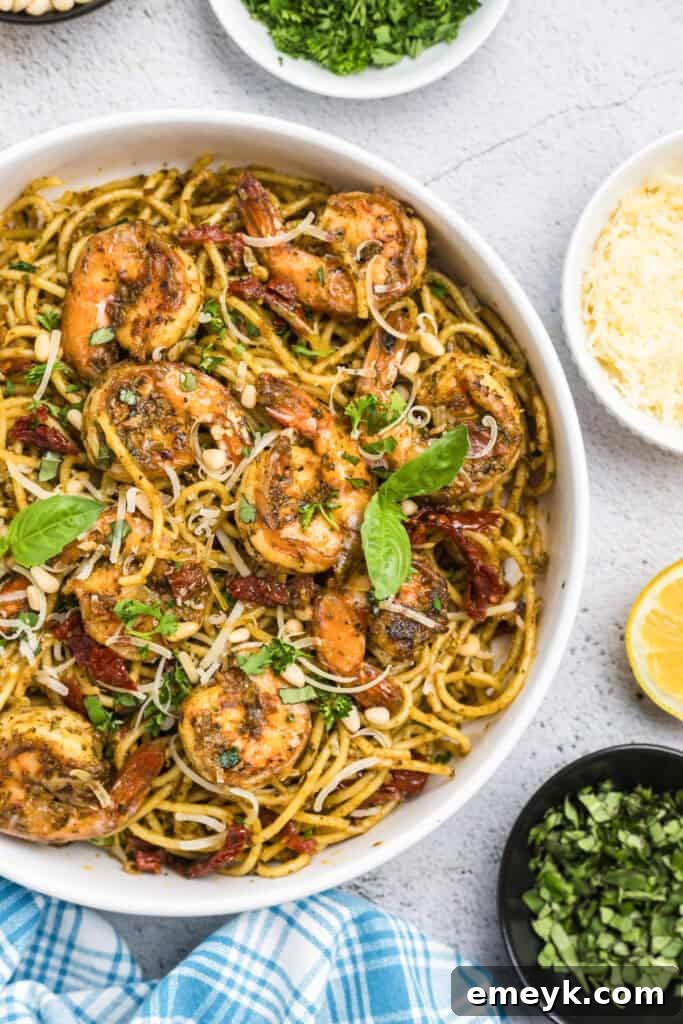 Vibrant Pesto Shrimp Pasta 7 Shrimp Pesto Pasta garnished with fresh basil leaves.