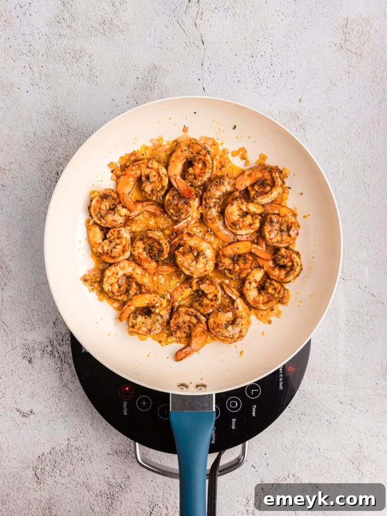 Vibrant Pesto Shrimp Pasta 9 Shrimp being sautéed in a pot for Pesto Pasta.