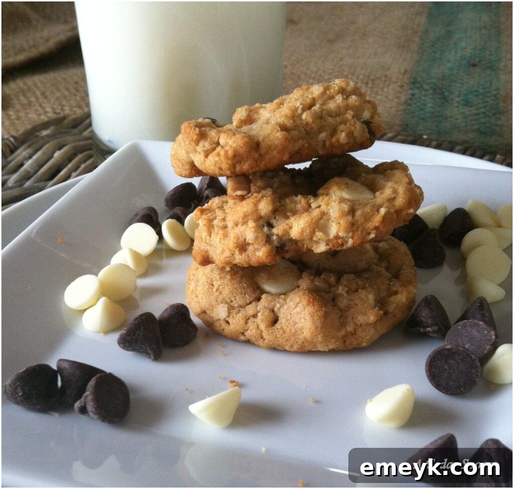 Close-up of a stack of Peanut Butter Oatmeal Two Chip Cookies, showcasing their chewy texture and generous chocolate chips.