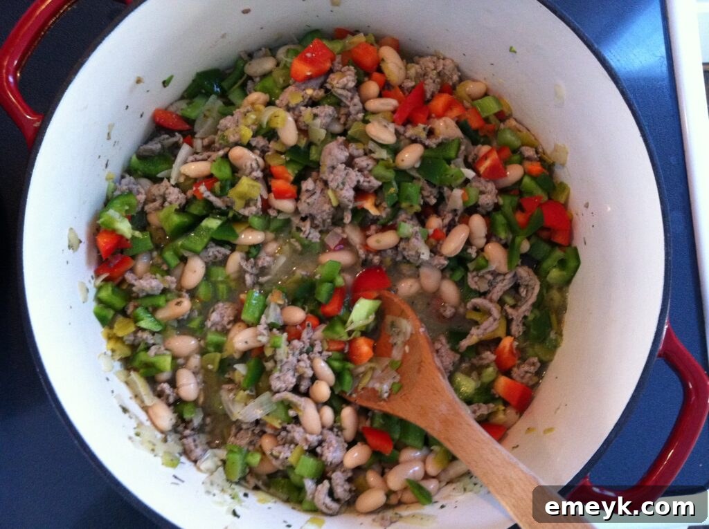 Large pot brimming with rich and hearty Cajun Green Chili