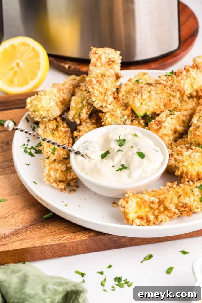 Crispy Air Fryer Zucchini Fries 2 Crispy Air Fryer Zucchini Fries on a plate with fresh parsley garnish.