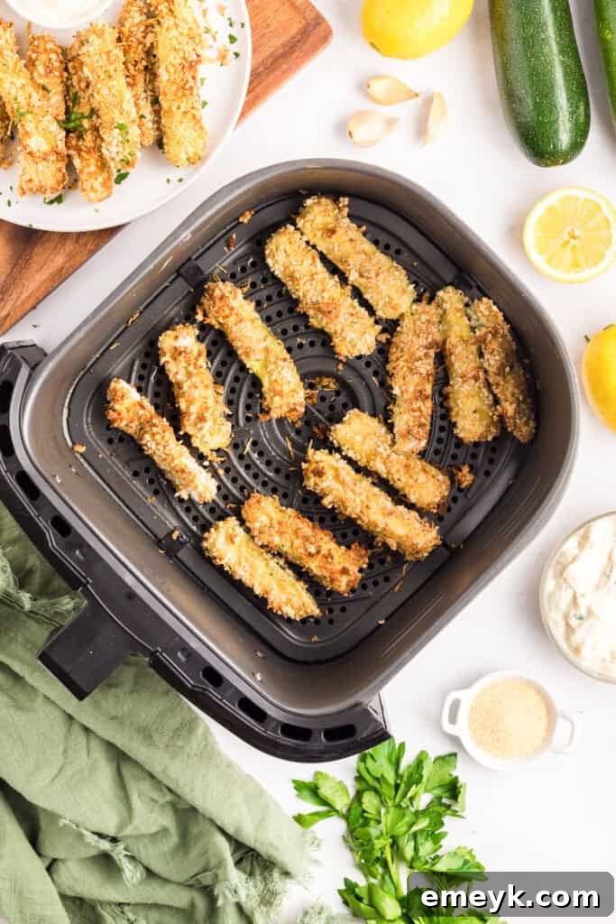 Crispy Air Fryer Zucchini Fries 15 Crispy zucchini fries cooking in the air fryer basket.