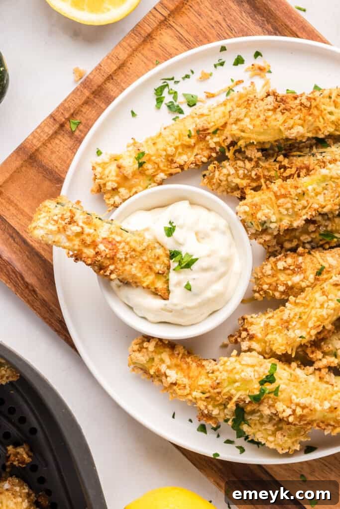 Crispy Air Fryer Zucchini Fries 7 Close-up of golden Air Fryer Zucchini Fries on a plate with a side of creamy Garlic Lemon Aioli.