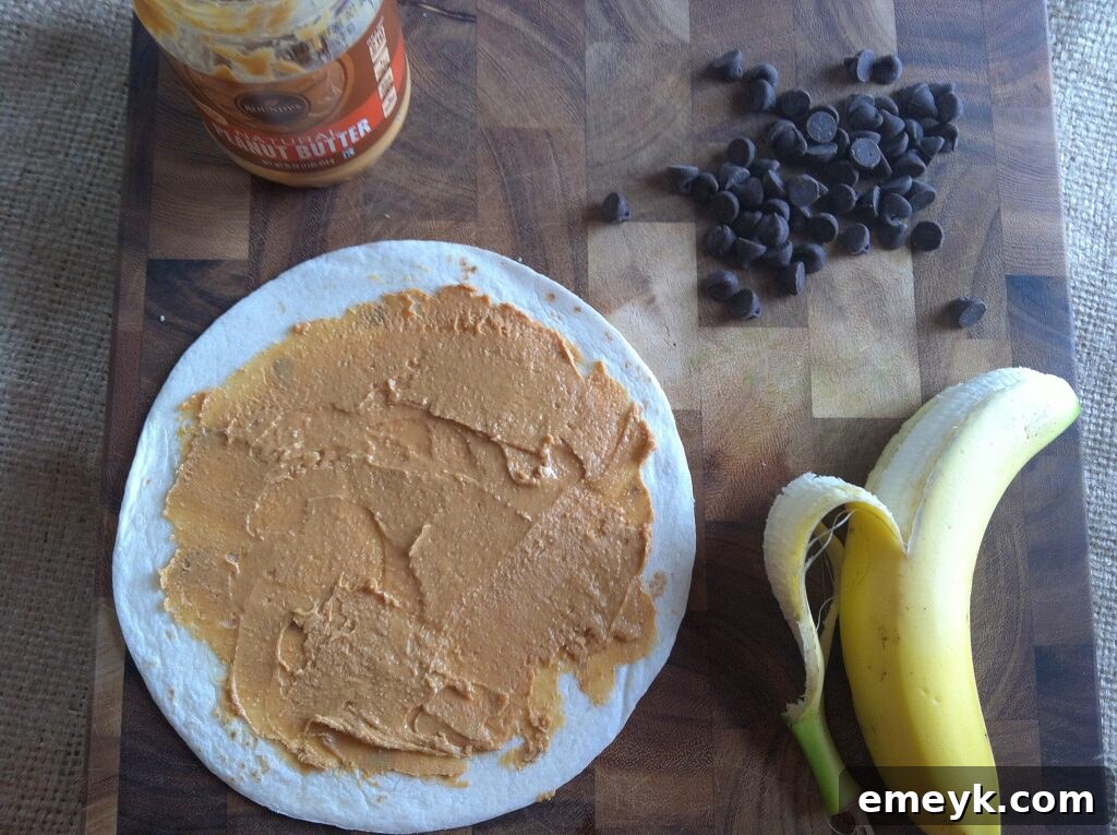 Evenly sliced bananas carefully arranged over the peanut butter on a tortilla, creating a sweet layer.