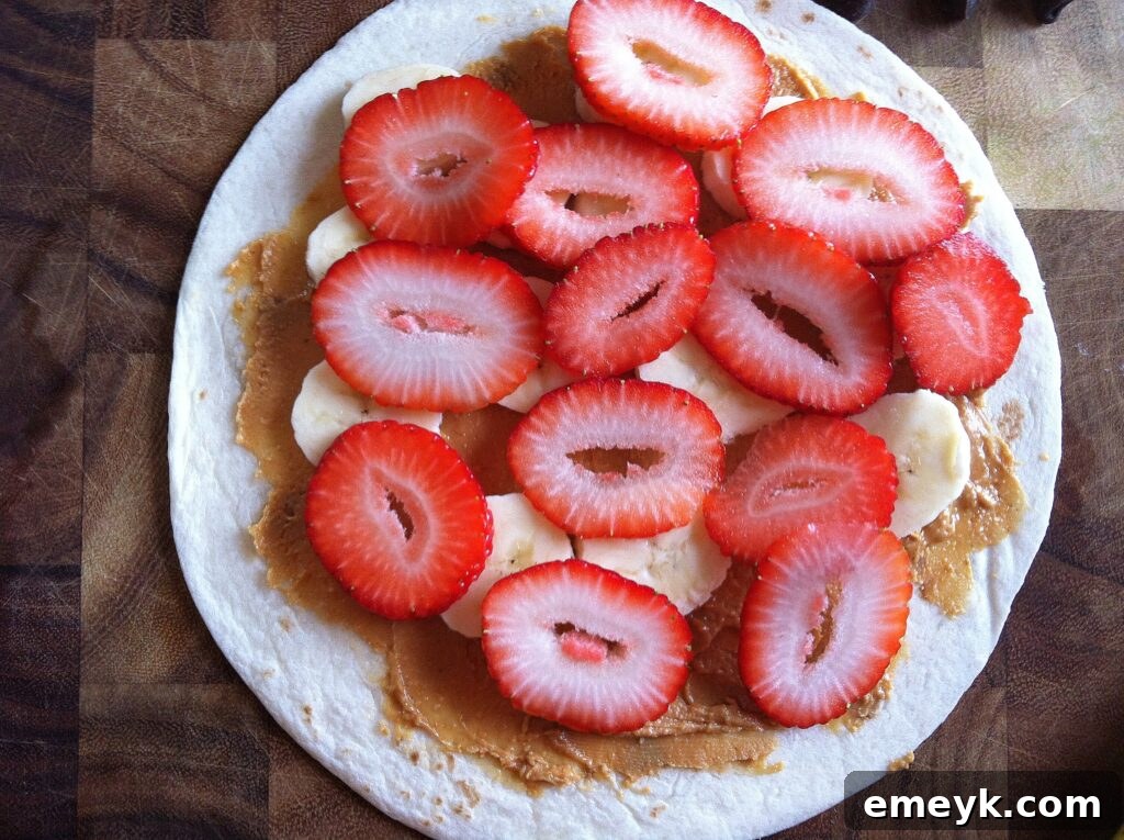 A generous sprinkling of chocolate chips covering the fruit layers on a tortilla.
