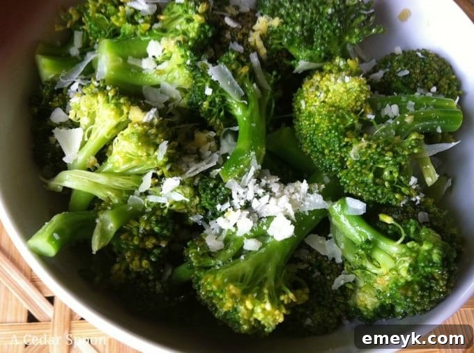 Roasted Lemon Parmesan Broccoli 4 A close-up shot of the perfectly cooked and seasoned Lemon Parmesan Broccoli in a white serving bowl.