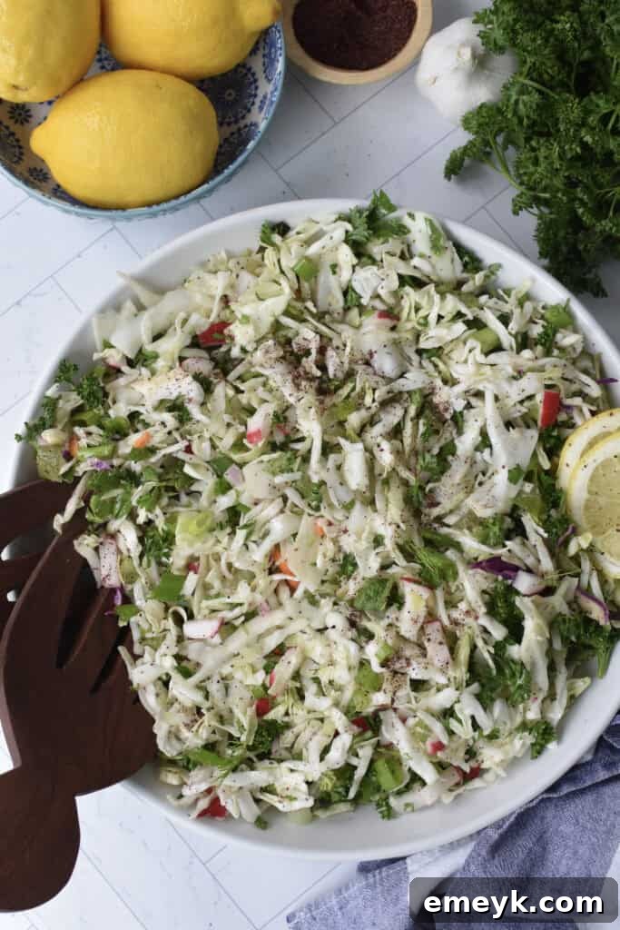 Malfouf Salad in a white bowl with a wooden spoon