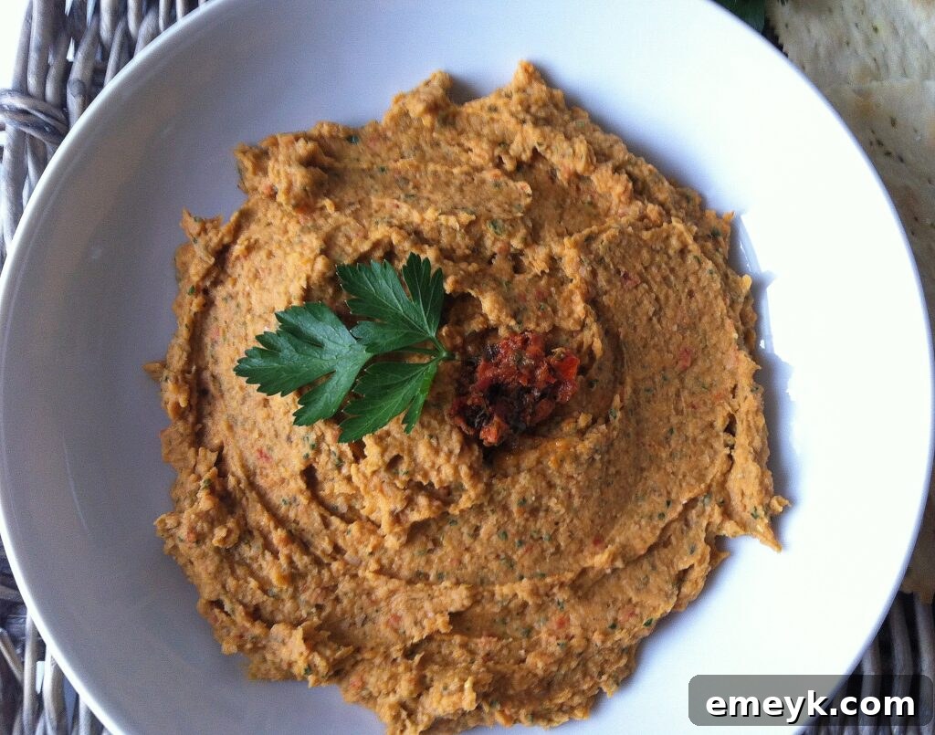 White Bean and Sun Dried Tomato Dip served as an appetizer with fresh herbs