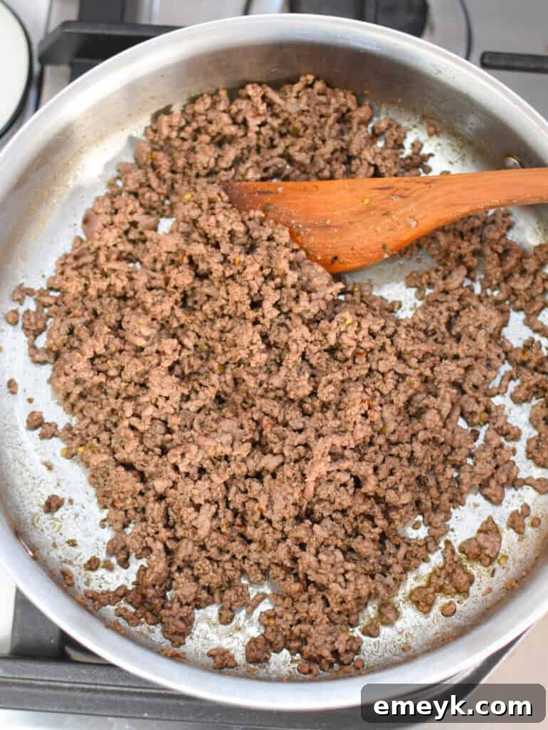 Beefed-Up Cottage Cheese Queso 6 Ground beef cooking in a skillet.