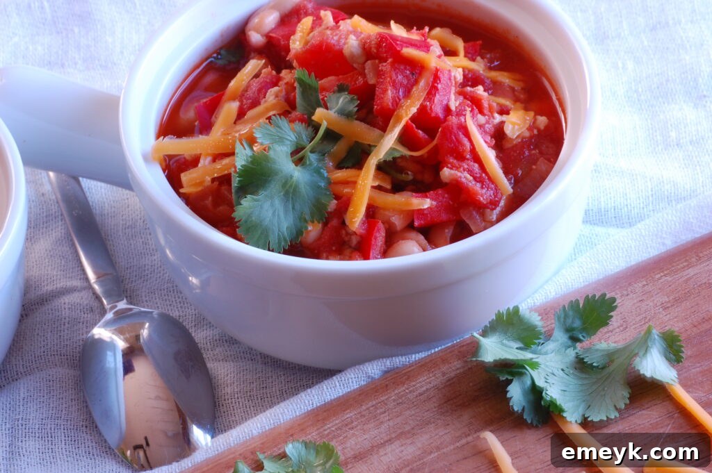 Close-up shot of the savory Turkey and White Bean Chili simmering in a pot, showcasing its rich texture and colorful ingredients.
