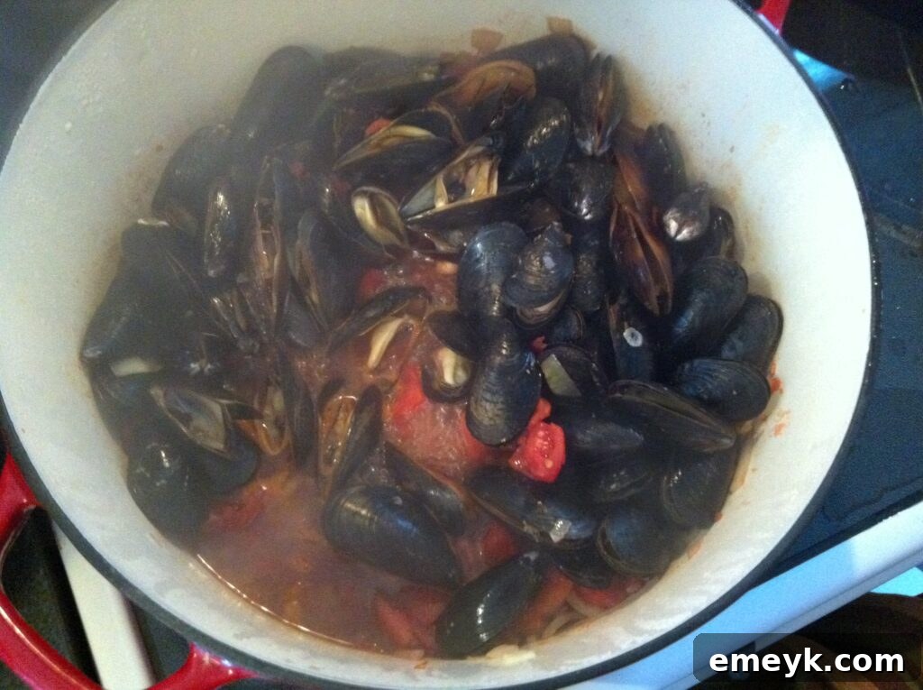 Steaming hot Mussels with Smoked Spanish Paprika served in a pot