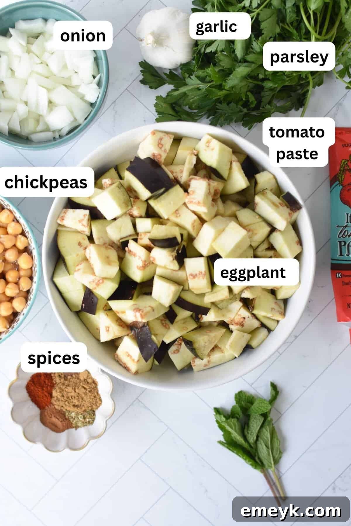 Lebanese Maghmour Hearty Eggplant and Lentil Casserole 5 A flat lay photograph showcasing all the fresh and dry ingredients needed for Lebanese Moussaka, neatly arranged on a countertop.