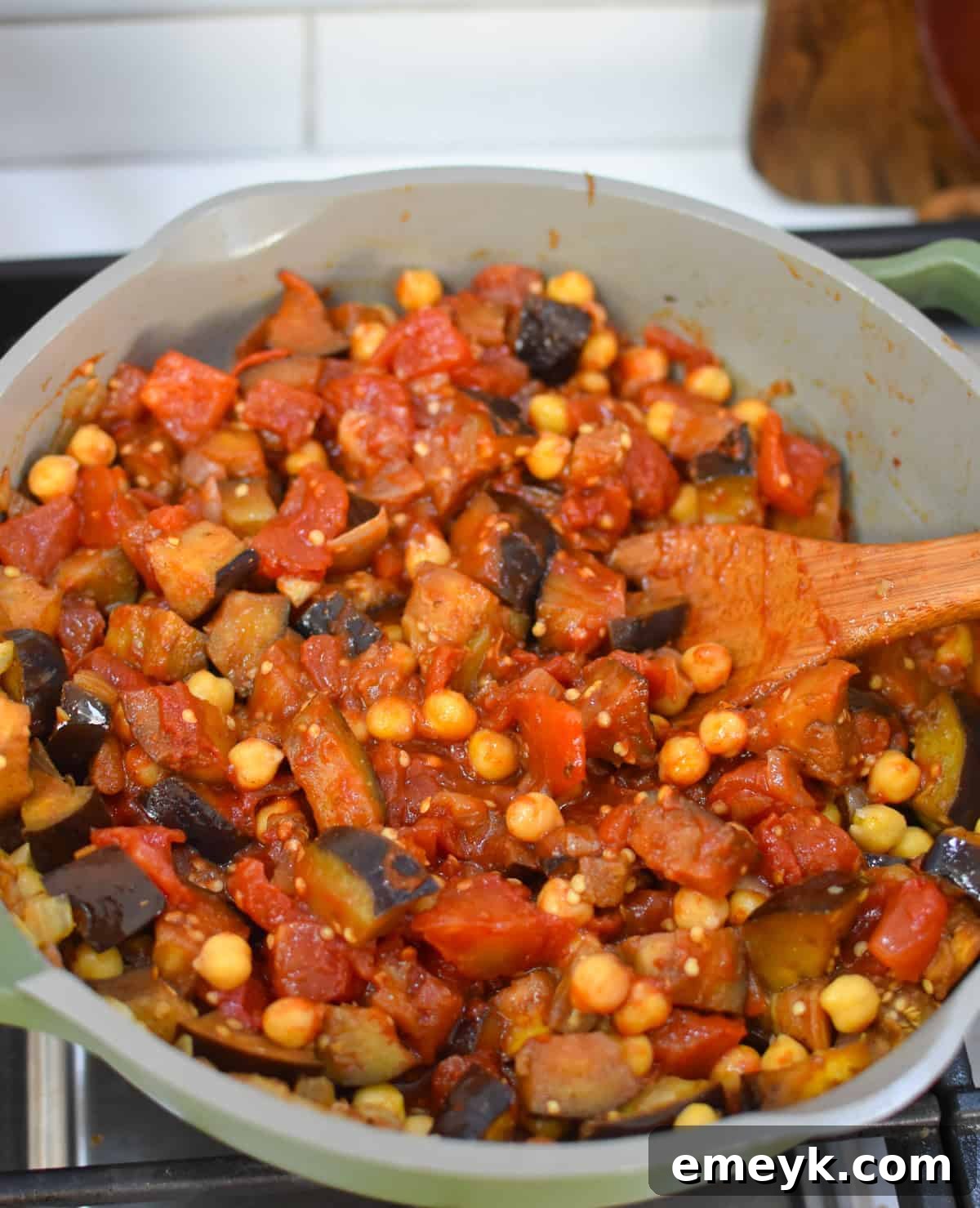 Lebanese Maghmour Hearty Eggplant and Lentil Casserole 10 The finished Lebanese Moussaka in a skillet, with a serving spoon, ready to be dished out.