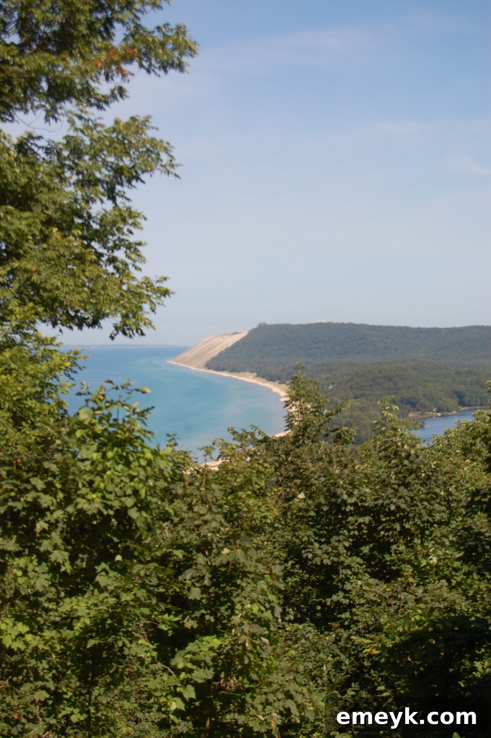 Sleeping Bear Dunes Coastal View Panoramic view of the Sleeping Bear Dunes coastline with lush greenery.
