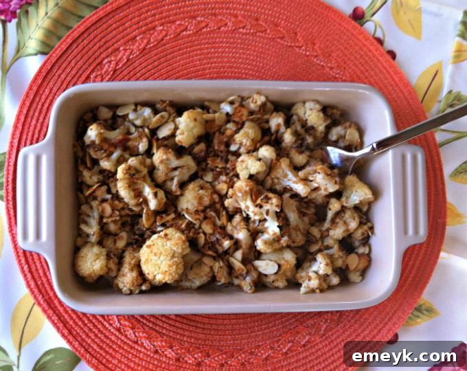 A serving bowl filled with a generous portion of the delightful roasted cauliflower side dish, ready to be served.