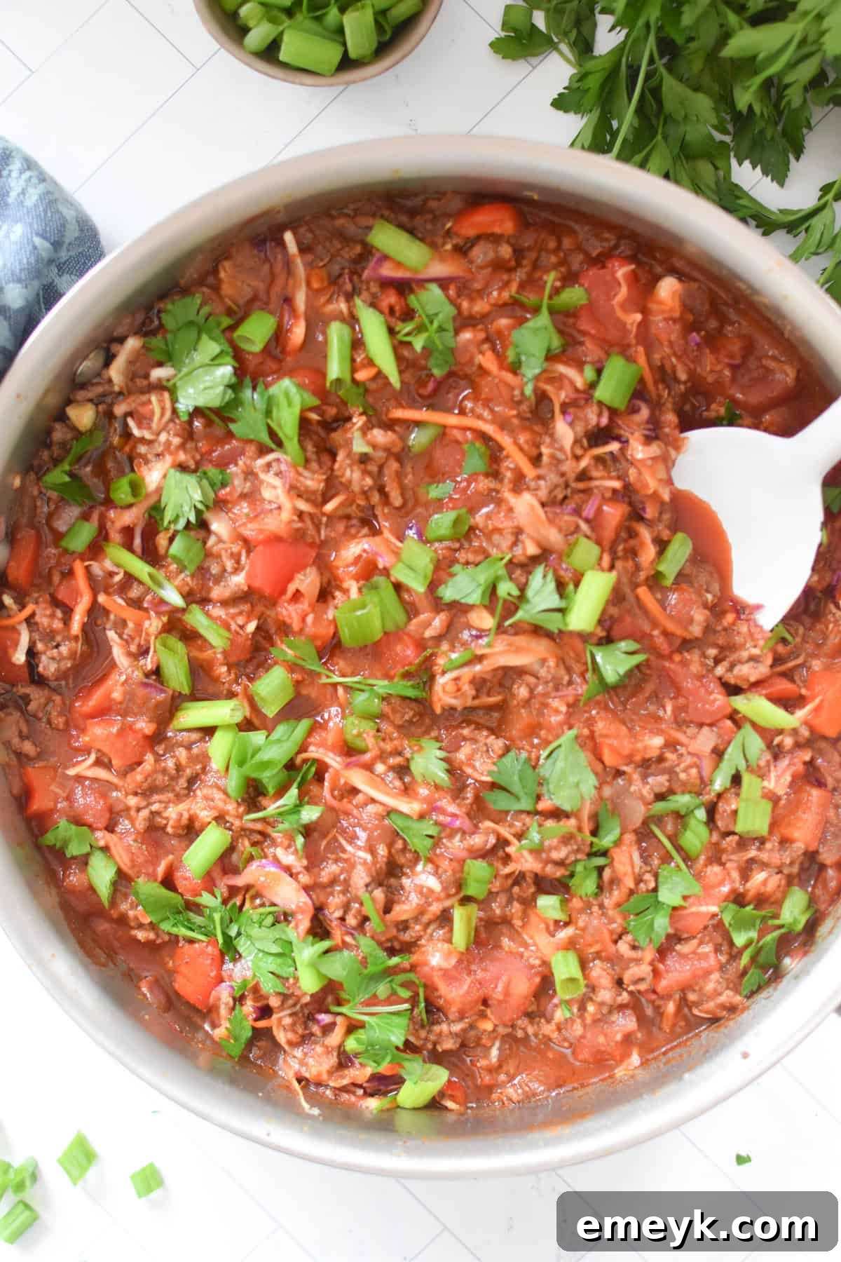 Zesty Mediterranean Beef and Cabbage Sauté 7 Mediterranean Beef and Cabbage Stir-fry with a white spoon