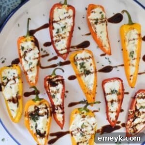 Goat Cheese Stuffed Mini Peppers on a white plate with balsamic glaze