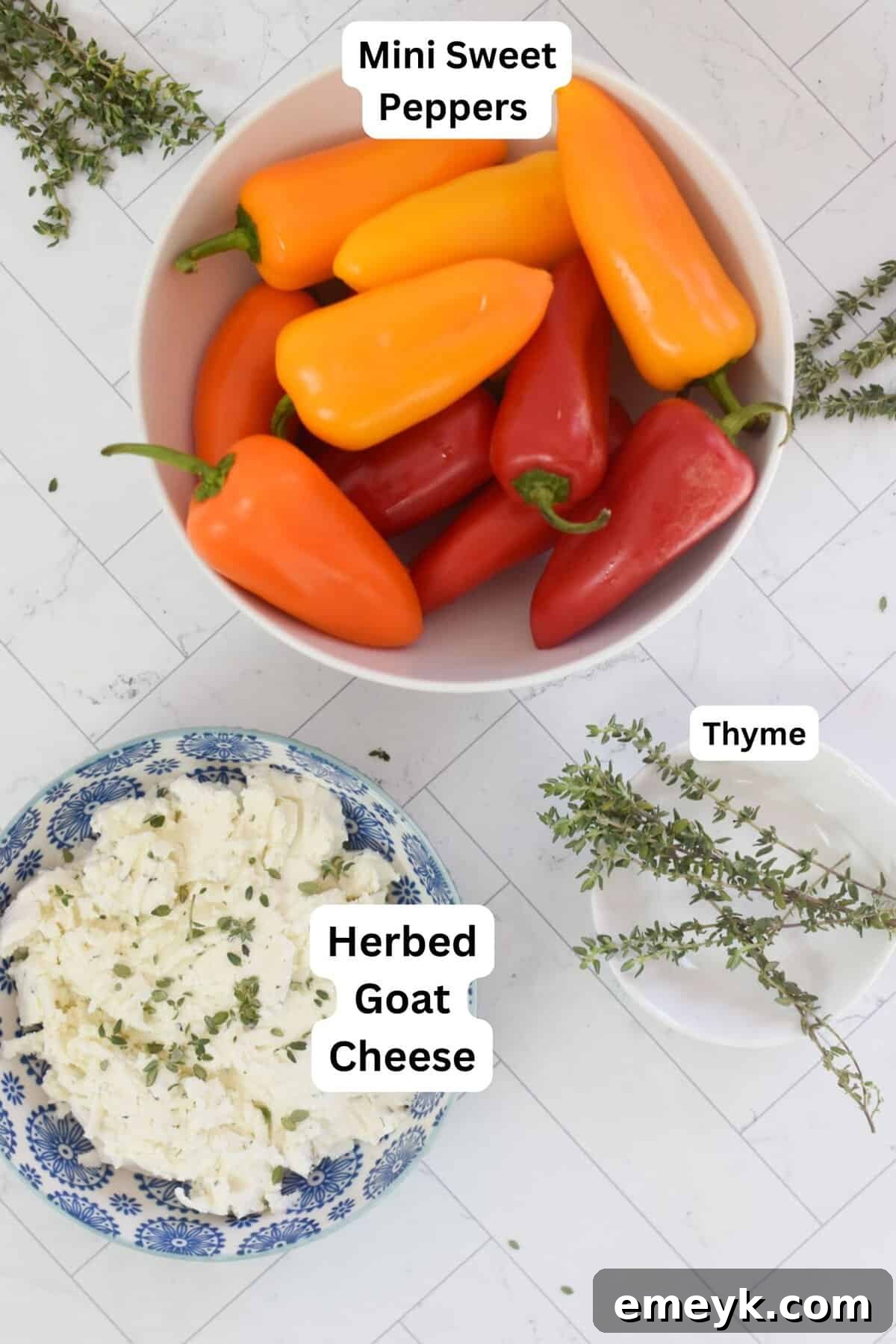 Creamy Goat Cheese-Filled Mini Peppers 6 A flat lay photograph showcasing all the fresh ingredients needed for Goat Cheese Stuffed Mini Peppers, including peppers, goat cheese, and herbs.
