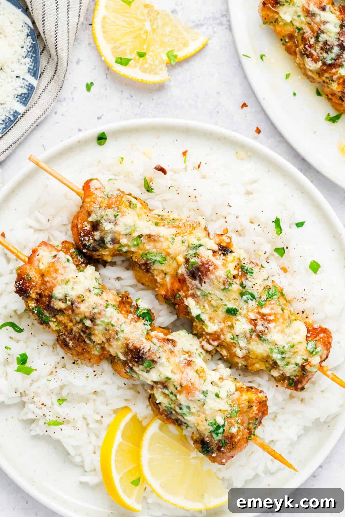 Juicy grilled chicken skewers generously brushed with garlic Parmesan butter sauce, ready to be enjoyed.