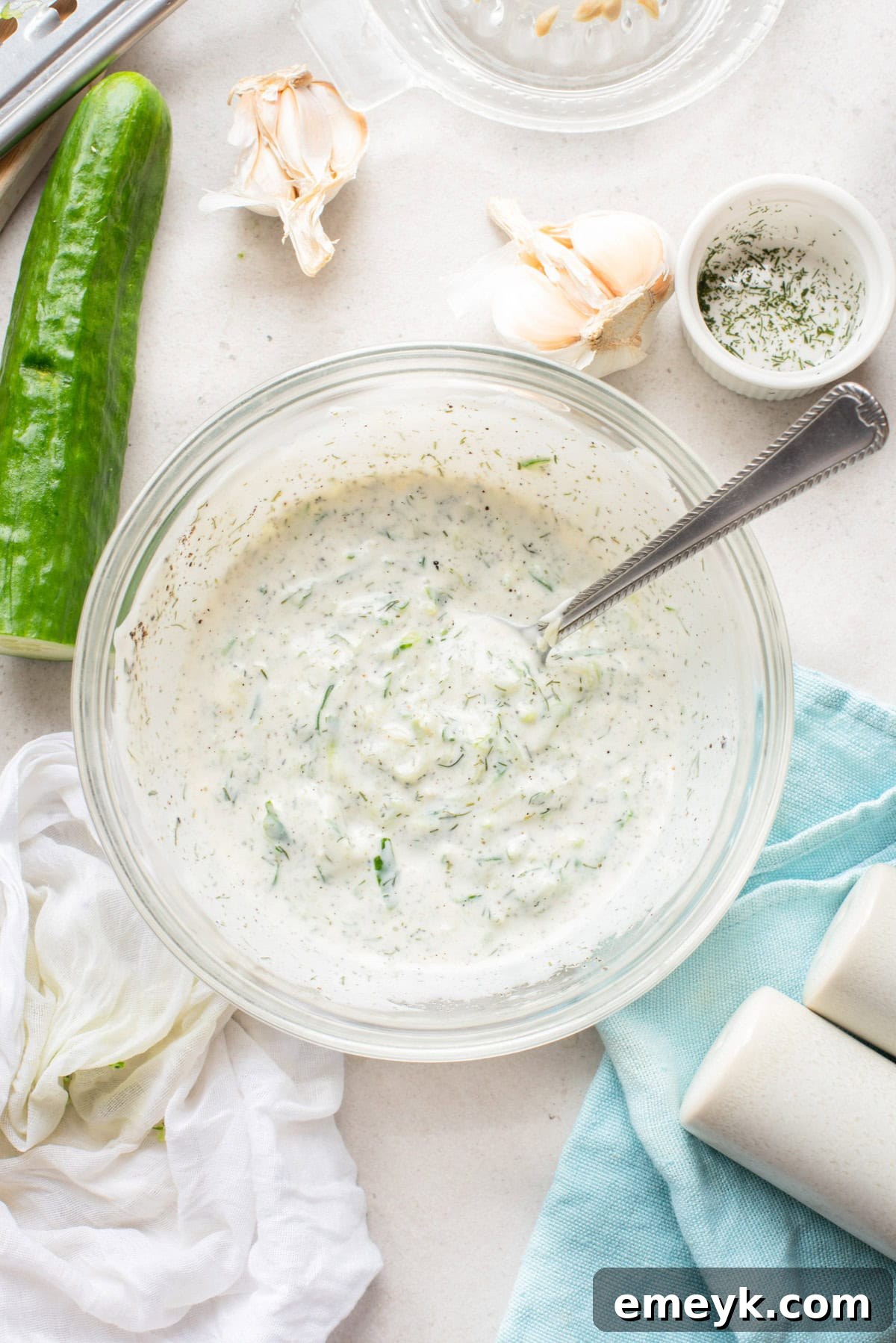 Greek cucumber dip in a bowl with a spoon, ready to be chilled