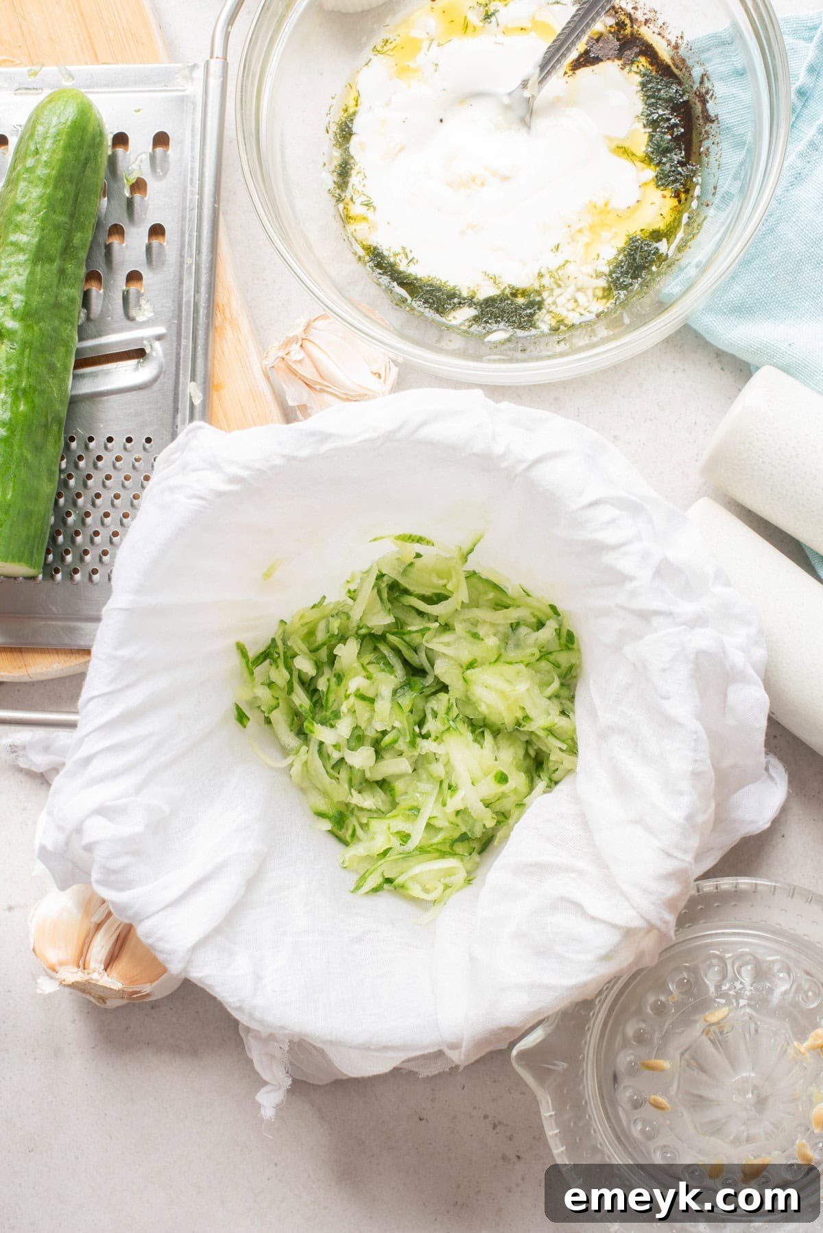 Easy Homemade Tzatziki Sauce: Grated cucumber in a dish