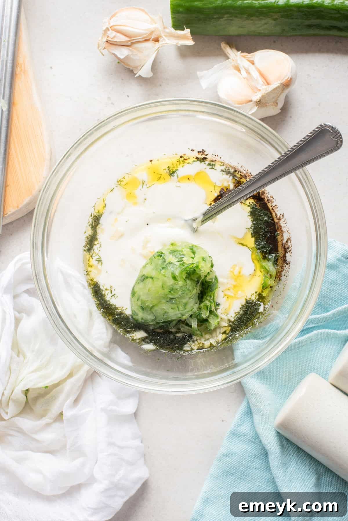 Cool and Creamy Tzatziki mixed in a bowl with a spoon