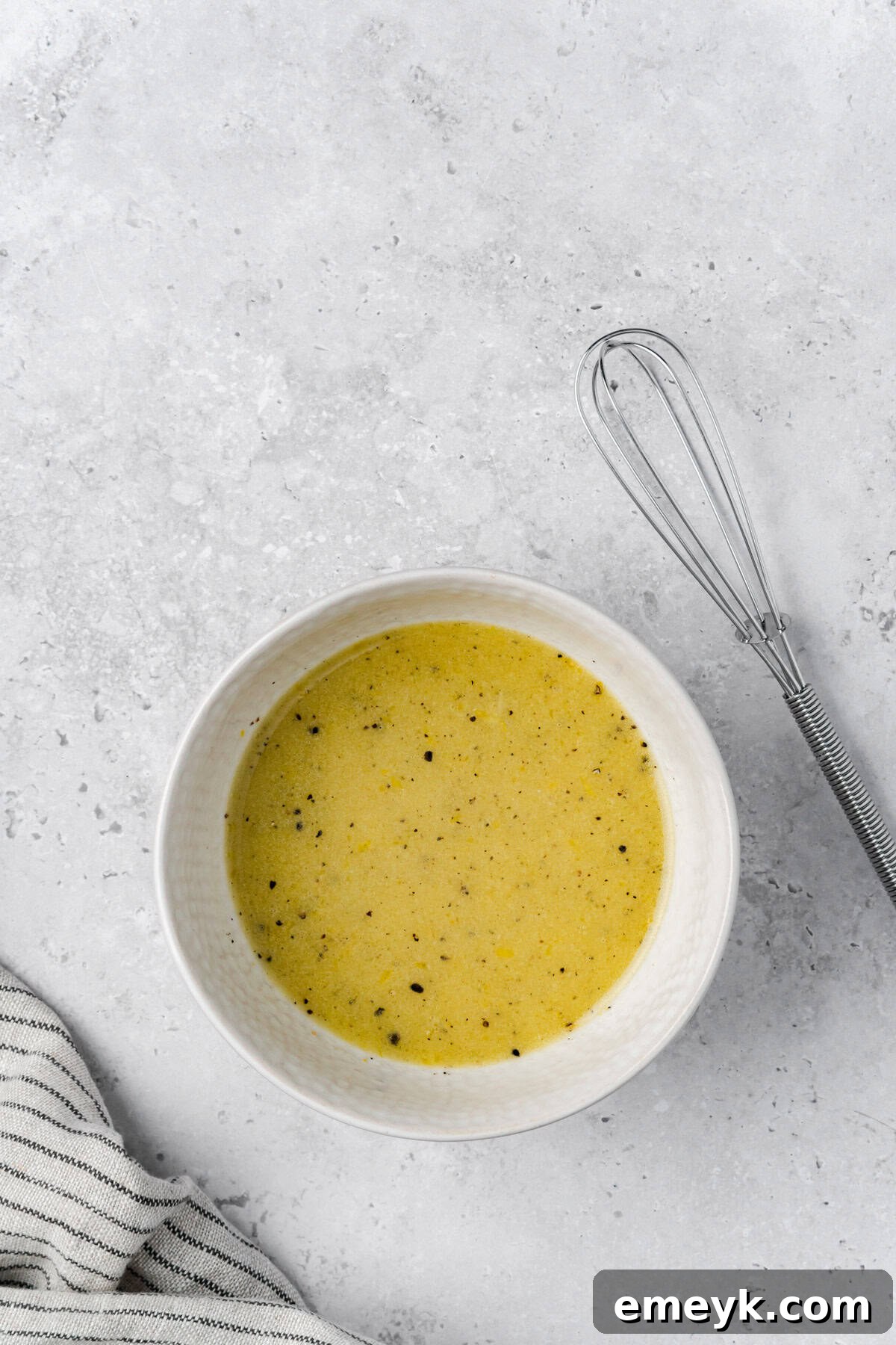 lemon shrimp orzo pasta salad dressing in bowl