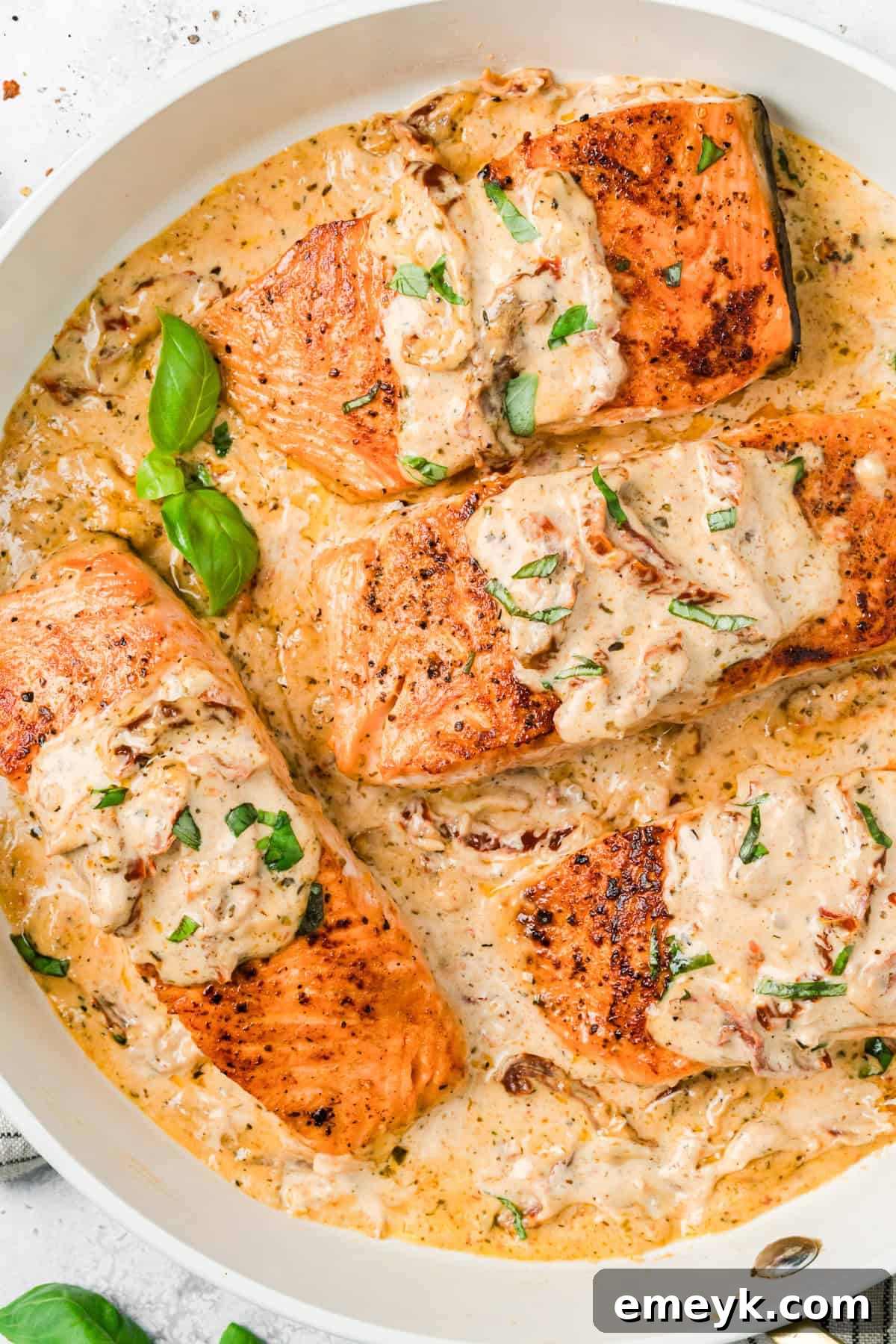 Marry Me Salmon Recipe in a skillet with basil 