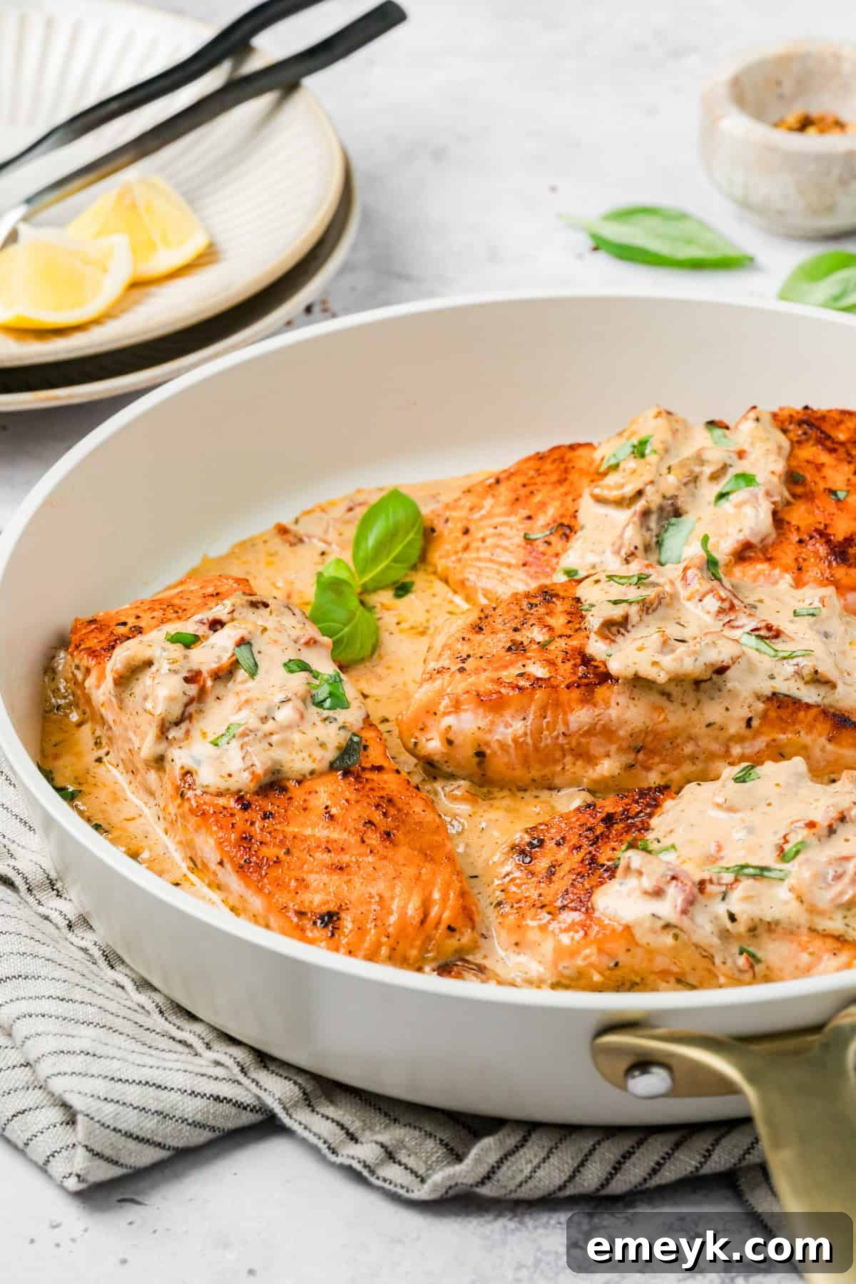 Easy Marry Me Salmon with fresh Basil in a skillet 